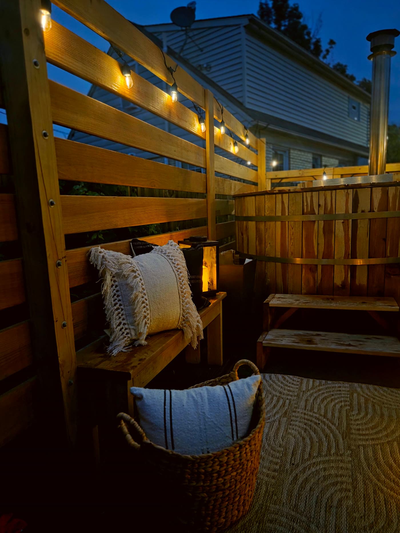 Cedar Soak hot tub deck set up at dusk with string lights