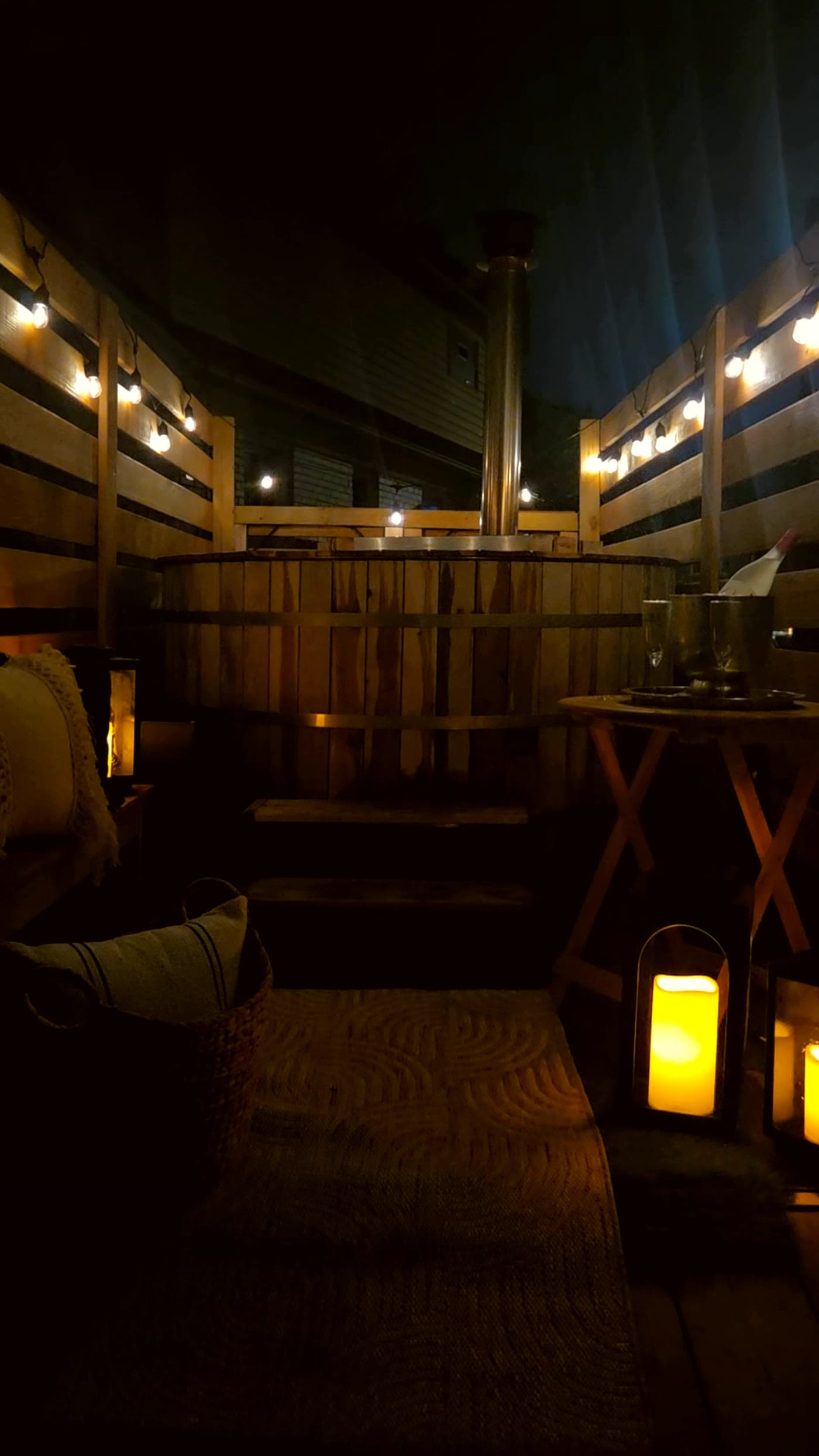 Cedar hot tub deck seating with lanterns and pillows
